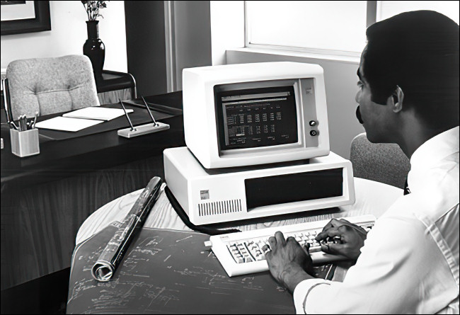 A man working on an IBM PC 5150.