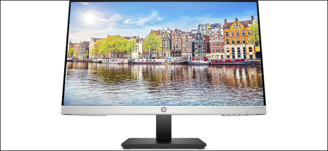 An HP monitor with an image of a European city displayed as wallpaper.