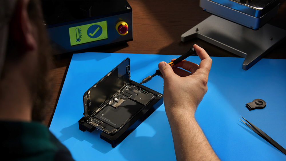 A photo of someone repairing an iPhone.